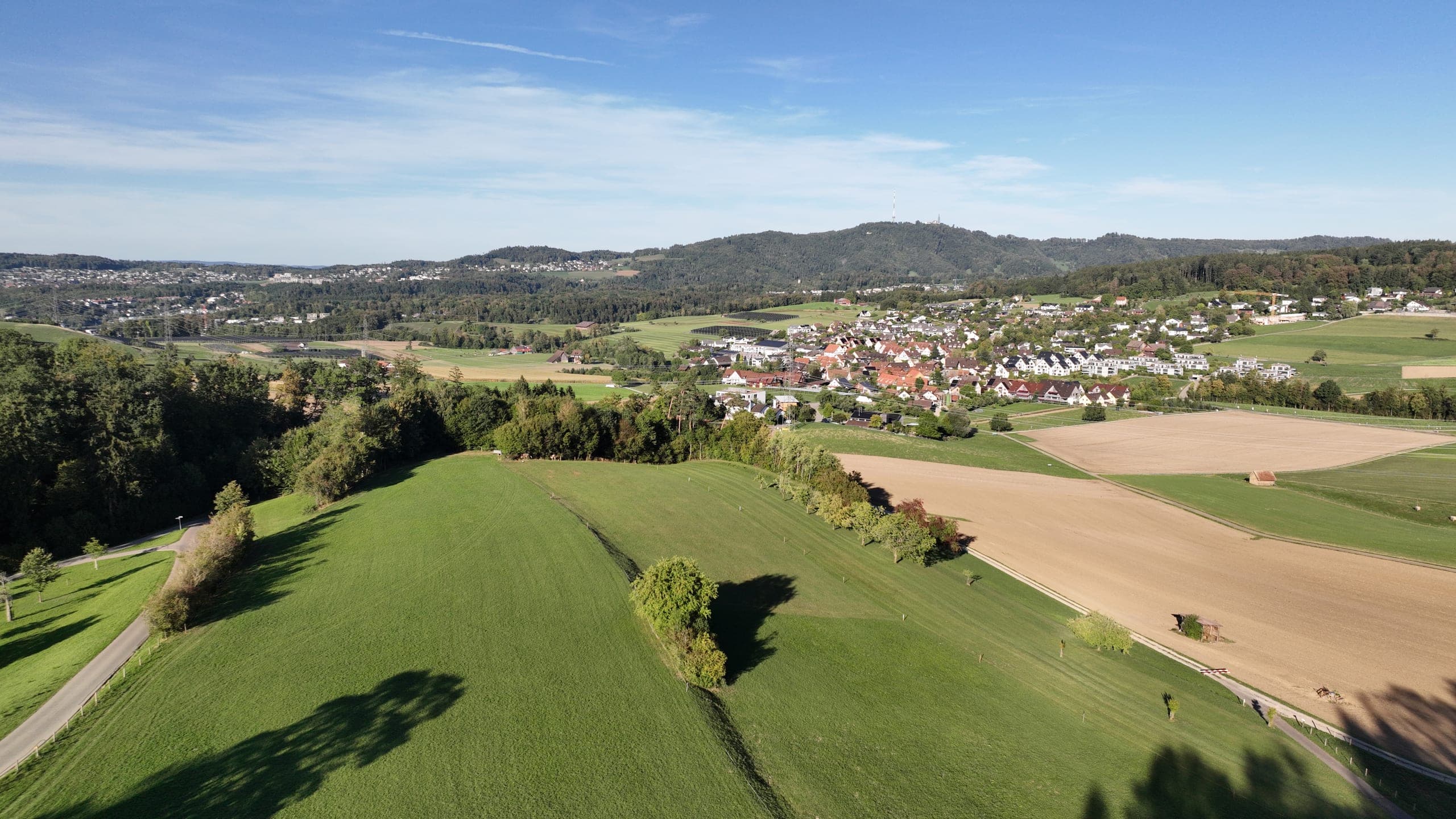Village between meadows and fields